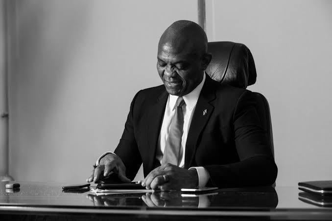 A gray picture of Tony Elumelu, the Founder of the Tony Elumelu Foundation sitting on a chair in his office 
