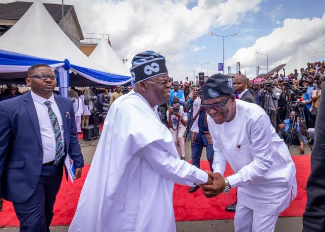 A picture of Minister Wike having a humble handshake with President Tinubu 