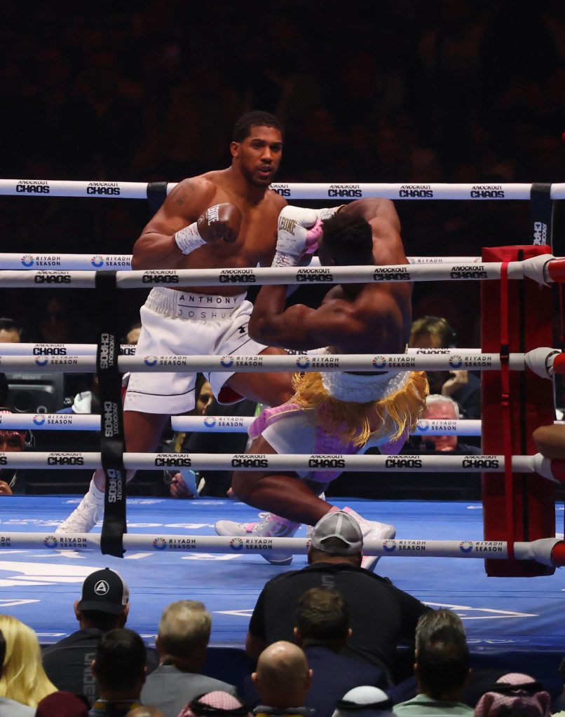 Anthony Joshua's Devastating Knockout ; Photo of the 2 fighters in the ring.