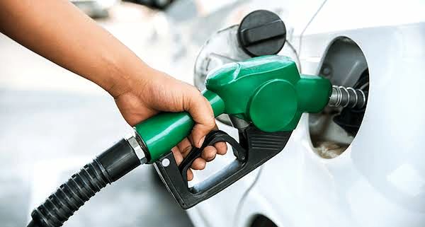 A picture of a hand filling the car of a customer with fuel at the Nigerian National Petroleum Company Limited (NNPCL) filling station 