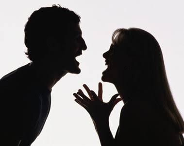 A black and white image of a couple screaming at each other in an argument 