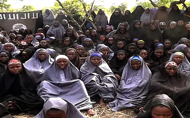 Pictures of the abducted Chibok school girl all seated on the ground 
